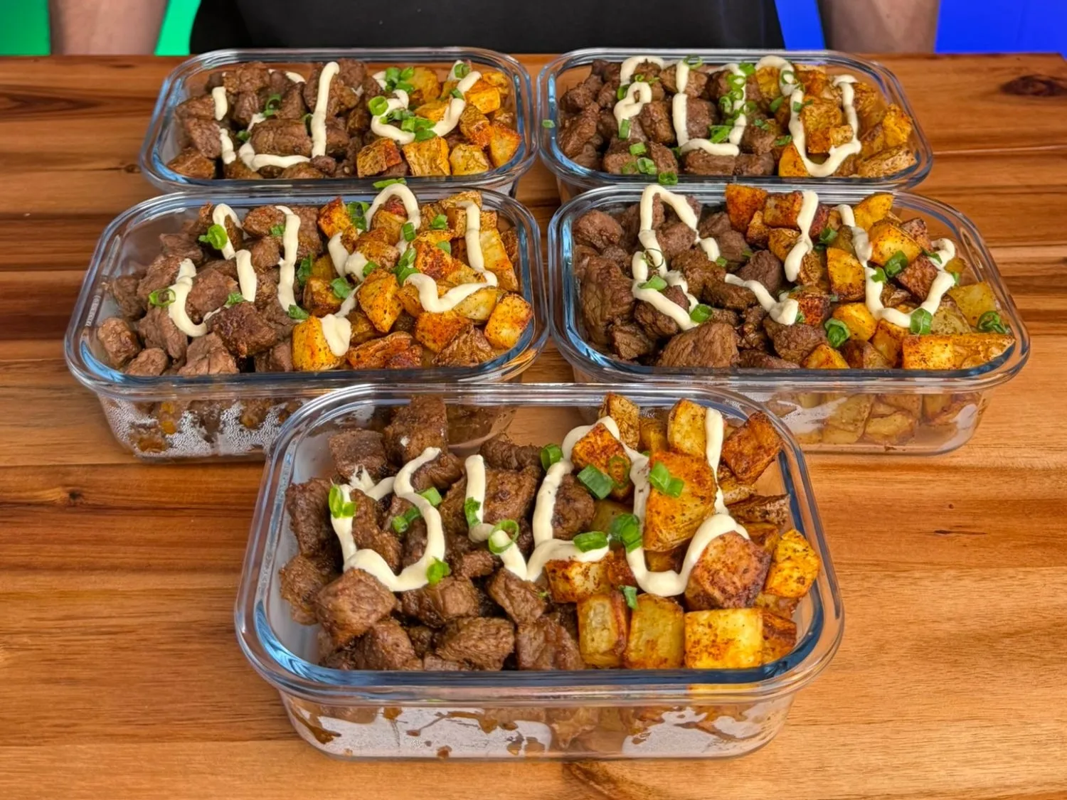Nacho Cheese Steak Bites and Crispy Potatoes meal prep on a wooden board