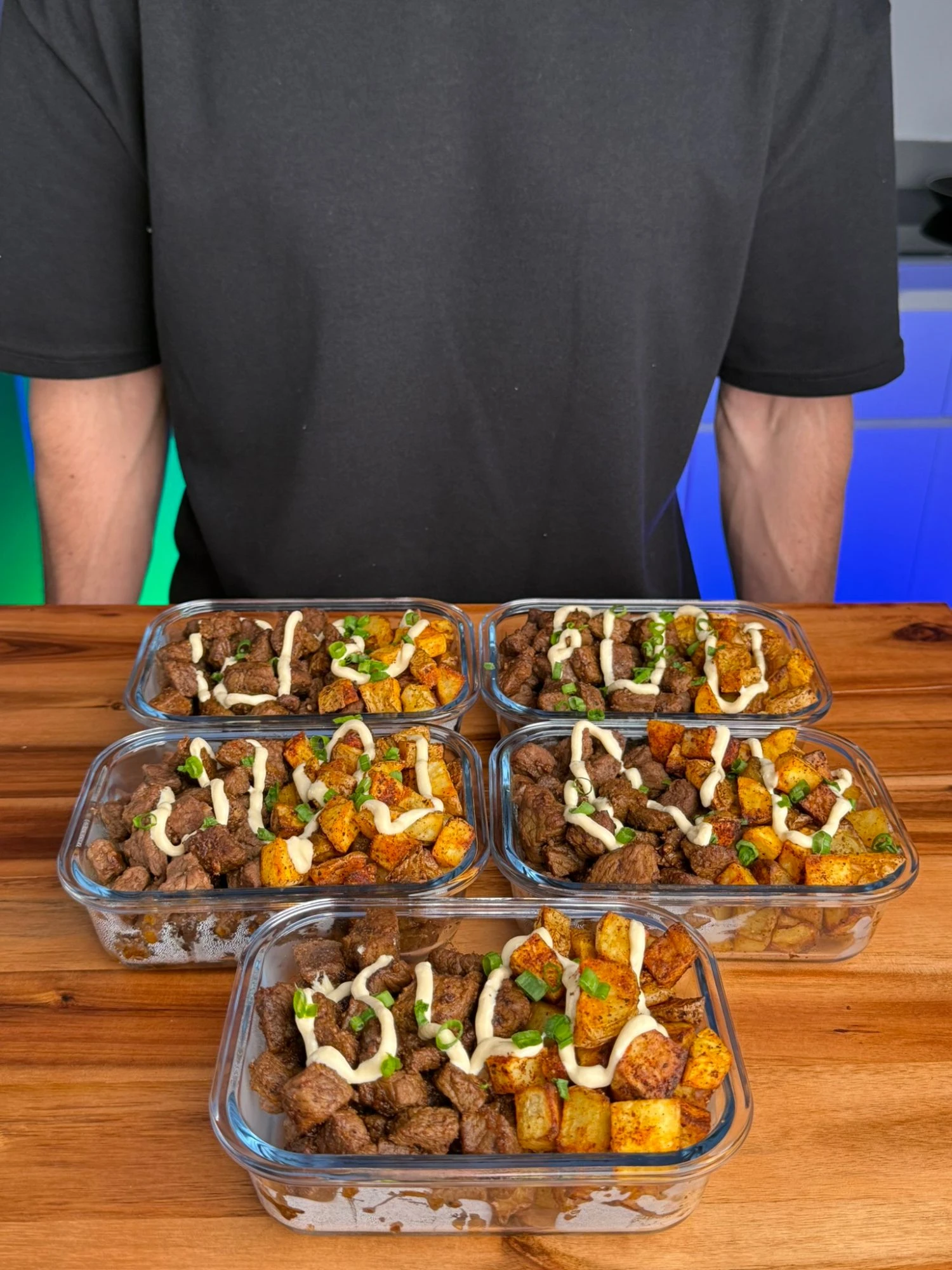 Nacho Cheese Steak Bites and Crispy Potatoes meal prep on a wooden board